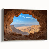 Framed canvas artwork showcasing a serene landscape with intricate cave formations, featuring a silver frame that enhances its elegance, ideal for modern decor.