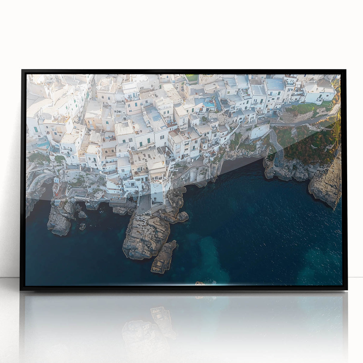 Framed acrylic artwork showcasing a dramatic landscape of rugged cliffs against a vibrant sunset, with a sleek black frame enhancing its modern aesthetic. Perfect for home decor or office spaces.