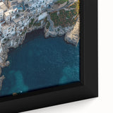 Close-up of a framed canvas art piece showcasing a dramatic landscape of cliffs against a vibrant sunset, highlighting rich colors and intricate details in the texture. Perfect for enhancing home decor with nature-inspired elegance.