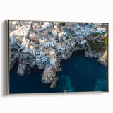 Framed canvas artwork depicting a stunning landscape of majestic cliffs under a vibrant sunset, featuring a sleek silver frame, perfect for home decor.