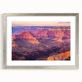 Framed landscape art print of majestic canyons in vibrant colors, featuring a sleek silver mat that enhances the scenic view, perfect for home decor.