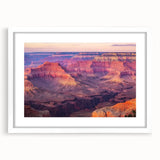 Framed landscape artwork depicting a stunning canyon scene with vibrant colors, set against a white mat, perfect for home decor and nature enthusiasts.