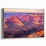 Framed canvas artwork showcasing a stunning landscape of canyons, featuring earthy tones and intricate details. The silver frame adds elegance, perfect for home decor.