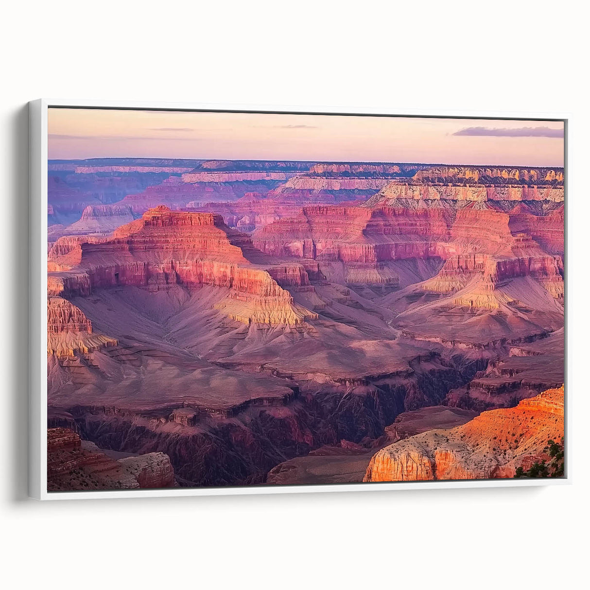 Framed canvas art depicting a stunning landscape of canyons, featuring vibrant colors and intricate details, showcased in a modern white frame for a contemporary aesthetic.