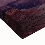 Close-up of a stretched canvas art piece showcasing a vibrant landscape of canyons, featuring rich hues of orange and deep blue, perfect for enhancing home decor.