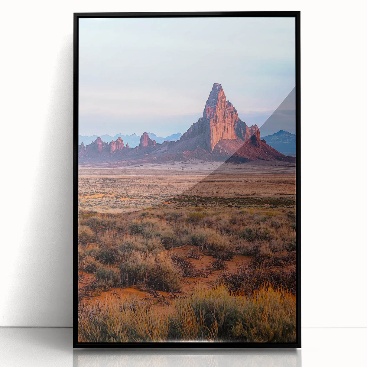 Framed acrylic artwork showcasing a serene desert landscape with golden dunes and a clear blue sky, presented in a sleek black frame for contemporary decor.