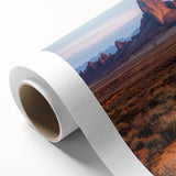 Rolled canvas showcasing a stunning desert landscape with golden dunes under a vibrant sunset, elegantly packaged in a protective cardboard tube for safe delivery.