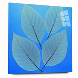 Large abstract wall art of close-up leaves in green and yellow tones, printed on acrylic glass.