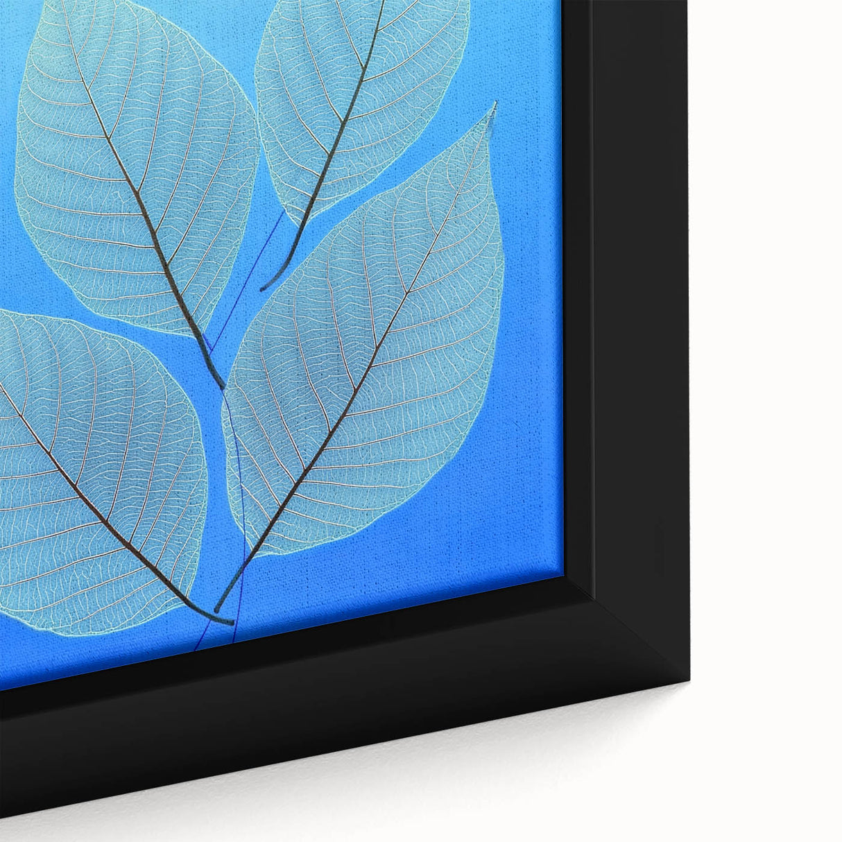 Close-up of textured black wall art featuring colorful leaves on a large framed canvas, ideal for living room decor.