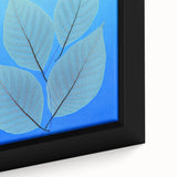 Close-up of textured black wall art featuring colorful leaves on a large framed canvas, ideal for living room decor.