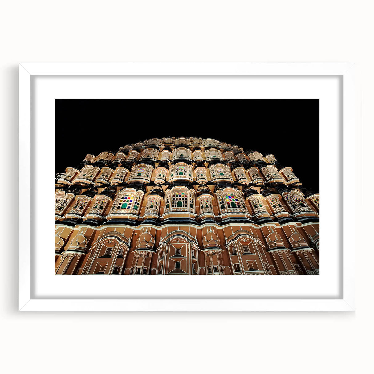 Abstract art print featuring vibrant hues of blue and orange in a minimalist style, framed with a white mat.