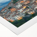 Rolled canvas showcasing a vibrant landscape featuring a majestic castle surrounded by lush greenery and a clear blue sky, elegantly packaged in a durable cardboard tube for safe transport.