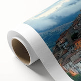 Detailed rolled canvas showcasing a vibrant landscape with a majestic castle, framed by lush greenery and a clear blue sky, ideal for home decor.