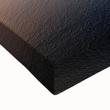 Close-up of a stretched canvas artwork depicting a dramatic landscape of cliffs under a vibrant sunset, showcasing rich colors and intricate details for home decor.