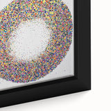 Close-up of a framed abstract canvas with colorful splatters, showcasing vibrant reds, blues, and yellows, ideal for modern home decor.