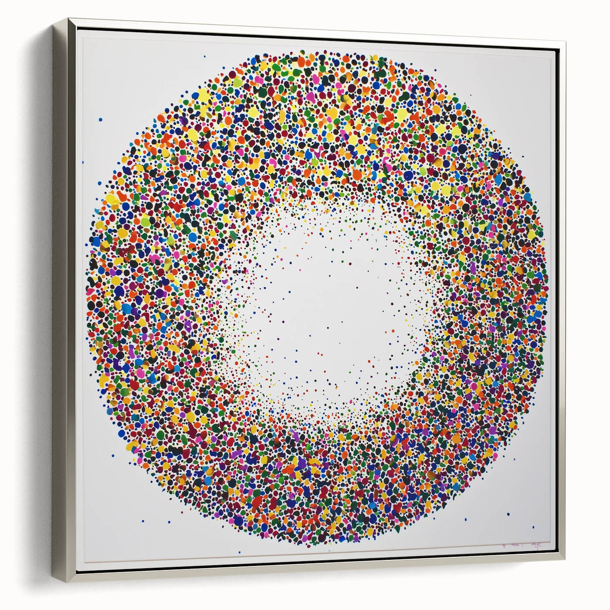 Abstract splatter art on a framed canvas with a silver border, showcasing vibrant colors and dynamic patterns, ideal for modern home decor.