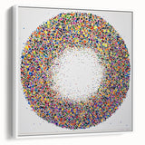 Framed canvas artwork displaying abstract paint splatters in vibrant colors, set against a white background, showcasing a modern aesthetic for contemporary decor.