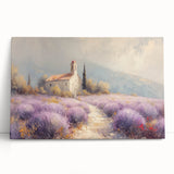 Stretched canvas artwork depicting a serene countryside landscape with vibrant green fields and a clear blue sky, leaning against a textured wall, ideal for home decor.