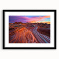 Framed desert landscape artwork with a black mat, showcasing vibrant hues of orange and yellow against a serene blue sky, perfect for modern home decor.
