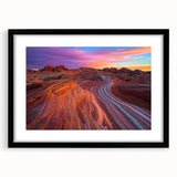 Framed desert landscape artwork with a black mat, showcasing vibrant hues of orange and yellow against a serene blue sky, perfect for modern home decor.