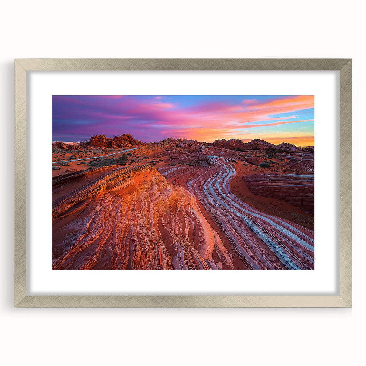 Desert landscape artwork framed with a silver mat, showcasing warm earth tones and intricate details, perfect for enhancing modern home decor.