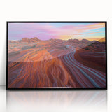 Framed acrylic artwork depicting a vibrant desert landscape with warm tones, featuring cacti and mountains, set in a sleek black frame, perfect for enhancing home decor.