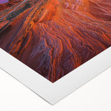 Desert landscape rolled canvas art showcasing vibrant hues of orange and yellow under a clear blue sky, elegantly packaged in a protective cardboard tube.