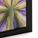 Close-up of a black framed canvas featuring textured, colorful floral designs, suitable for living room decor.