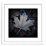Abstract art print featuring close-up of green leaves, in a white frame, suitable for bedroom or dining room decor.