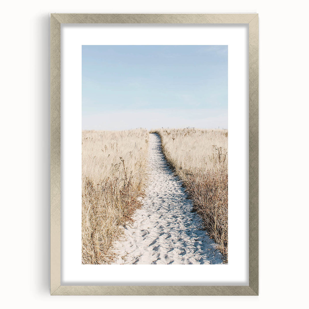 Textured abstract art print in warm orange and yellow tones, framed in silver, ideal for bedroom decor.