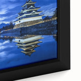 Close-up of a beautifully framed canvas print showcasing a serene landscape with a castle, featuring rich colors and intricate details, ideal for home decor.