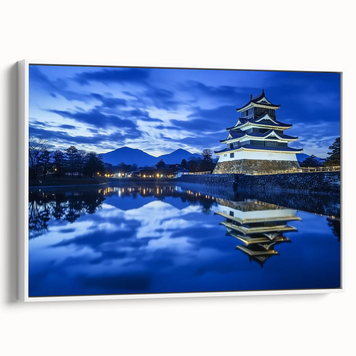 Framed canvas artwork showcasing a serene landscape with a majestic castle, featuring vibrant colors and intricate details, displayed against a white background for an elegant look. Perfect for enhancing interior decor.
