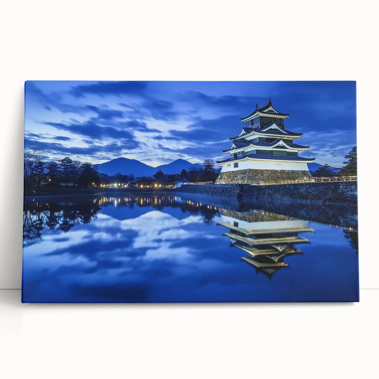 Stretched canvas artwork depicting a serene landscape with a majestic castle nestled among lush green hills, showcasing vibrant colors and intricate details, perfect for home decor.