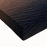 Close-up of a stretched canvas showcasing a dramatic landscape of rugged cliffs against a vibrant sky, emphasizing texture and detail, perfect for home decor.