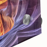 Close-up of a vibrant acrylic glass print depicting colorful canyons and landscapes, showcasing intricate details and textures, perfect for modern home decor.