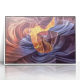 Framed acrylic artwork depicting a stunning landscape of vibrant canyons in earthy tones, set against a sleek white frame, ideal for modern home decor.