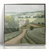 Framed landscape wall art depicting a serene countryside scene with vibrant green fields, soft blue skies, and a silver-acrylic finish, perfect for home decor.