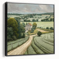 Framed landscape wall art depicting a serene countryside scene with green hills and a blue sky, featuring a sleek black frame for modern decor.