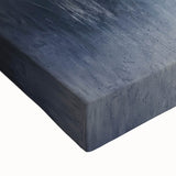 Close-up of a stretched canvas artwork depicting a serene countryside landscape, showcasing vibrant green fields, rolling hills, and a clear blue sky, perfect for home decor.