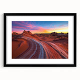Framed landscape artwork depicting a vibrant desert scene with rich colors, featuring a black mat border and sleek frame, ideal for modern home decor.