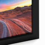 Close-up of a framed canvas artwork depicting a vibrant desert landscape, showcasing warm hues of orange and yellow with intricate textures, ideal for home decor.
