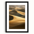 Framed landscape artwork showcasing serene sand dunes in soft beige and gold tones, accented by a sleek black mat and frame, perfect for modern home decor.