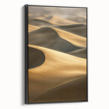 Framed canvas artwork depicting serene sand dunes landscape in neutral tones, featuring a sleek black frame, perfect for modern home decor and enhancing any space.