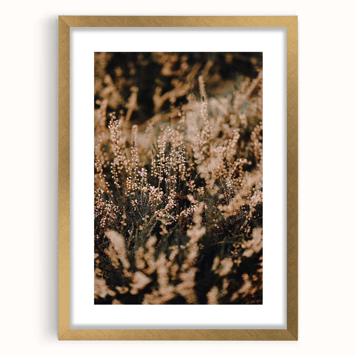 Abstract art print featuring textured autumnal hues on a large canvas, framed in gold, ideal for living room decor.