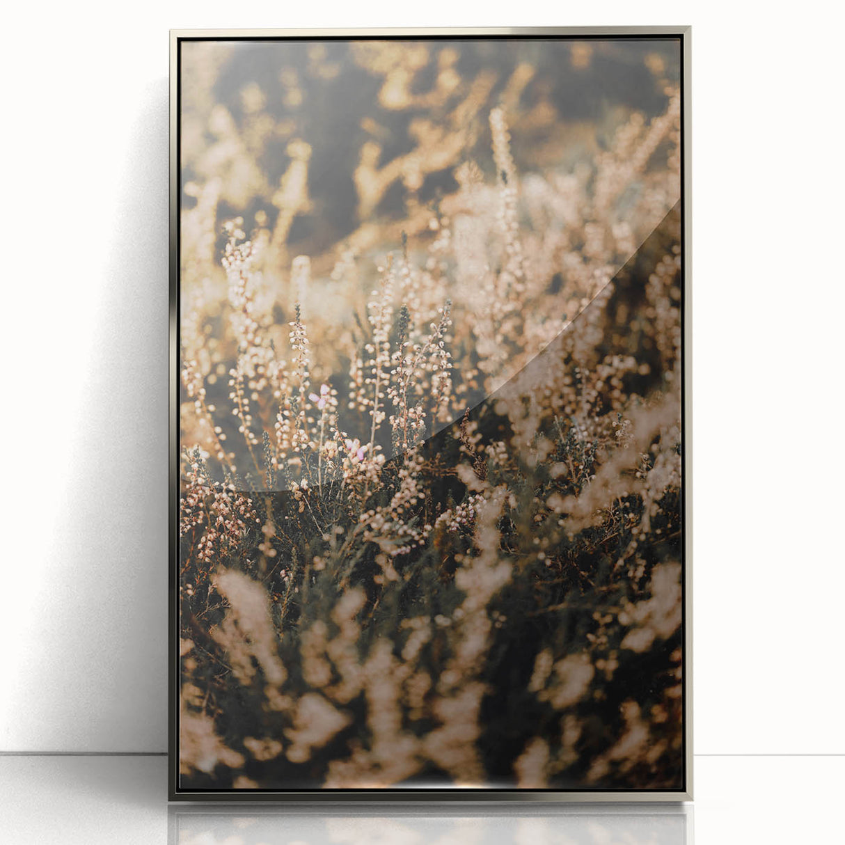 Mid-century modernist art depicting an autumnal scene in muted orange and brown tones, framed in silver acrylic.