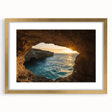 Framed landscape print showcasing a serene cave scene with gold matting, ideal for home decor. The elegant design enhances any room's ambiance.