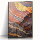 Framed acrylic artwork showcasing a dramatic landscape of towering cliffs under a vibrant sunset, featuring silver accents that enhance its modern aesthetic.