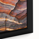 Close-up view of a framed canvas depicting a stunning landscape of rugged cliffs, showcasing rich textures and vibrant colors, ideal for home decor enhancement.
