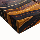 Close-up of a stretched canvas artwork depicting dramatic cliffs and landscapes in vibrant colors, ideal for enhancing home decor with nature-inspired art.