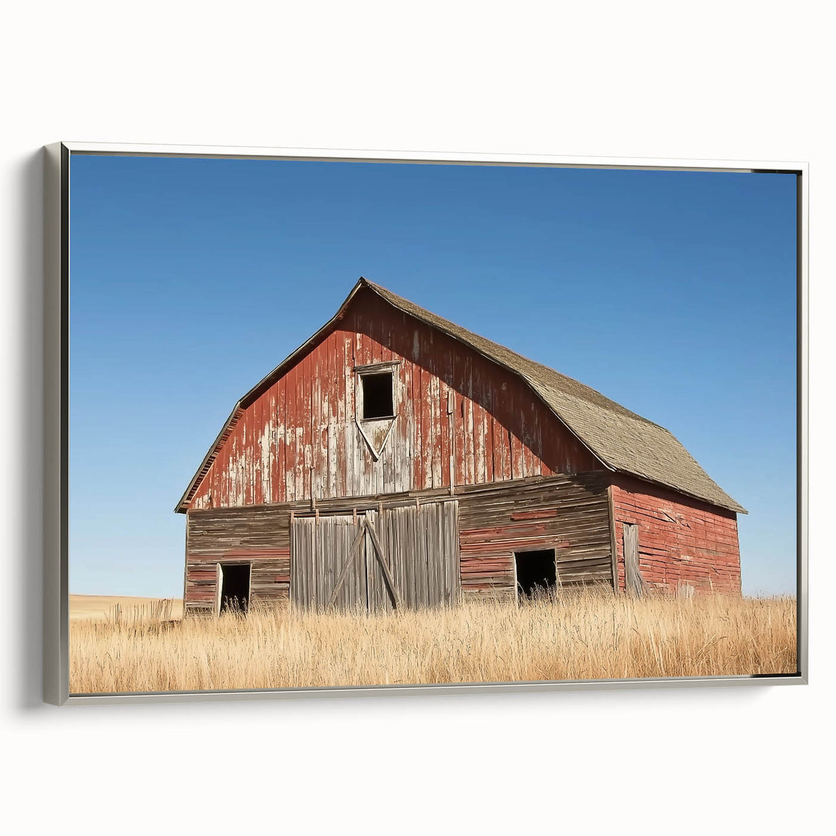 Landscape barn-themed canvas artwork displayed in a silver frame, showcasing vibrant colors and rustic charm; perfect for enhancing home decor settings.
